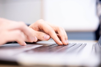 up close of hands typing on a keyboard