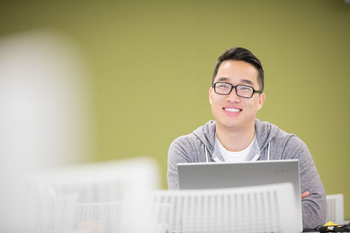 student in lecture w/ green background