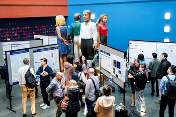 People at a scientific poster session in a large lobby